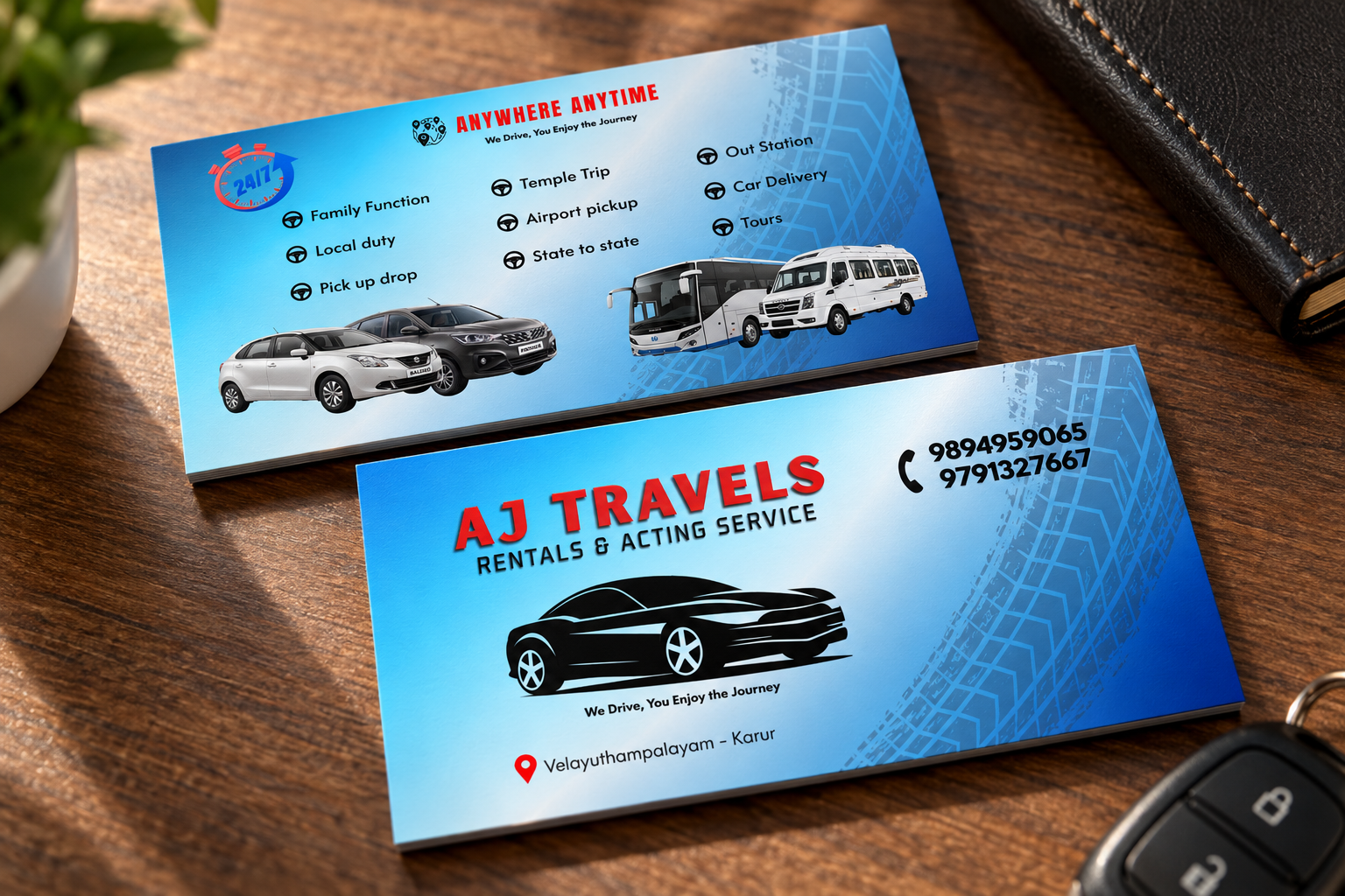 Printed AJ Travels business cards resting on a wooden table